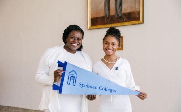 Spelman College female students holding a Spelman College banner