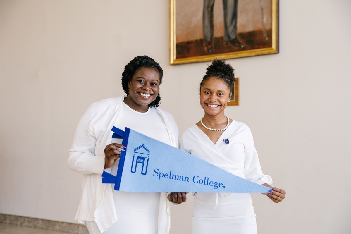 Spelman College female students holding a Spelman College banner