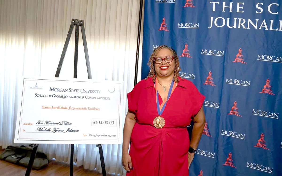 Michelle Tyrene Johnson accepting Morgan State Journalism Award with large 10,000 check in the background