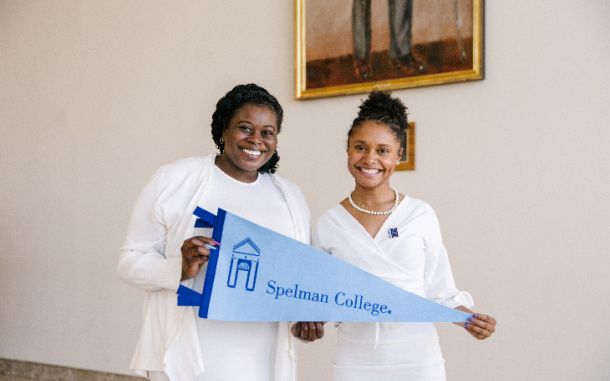 Spelman College female students holding a Spelman College banner